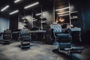 An interior view of a barbershop with multiple seating chairs for customers